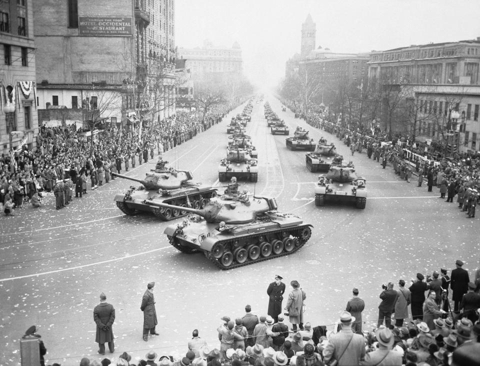 Army medium tanks move along Pennsylvania Avenue between spectator-crowded sidewalks in the big Inaugural Parade for Pres. Dwight D. Eisenhower, Jan. 21, 1953, Washington, D.C. Front tanks are turning into 15th Street on way to the reviewing stand set up in front of White House. (AP Photo)