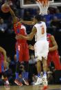 Dayton guard Scoochie Smith (11) and Florida guard Kasey Hill (0) vie for a loose ball during the first half in a regional final game at the NCAA college basketball tournament, Saturday, March 29, 2014, in Memphis, Tenn. (AP Photo/John Bazemore)