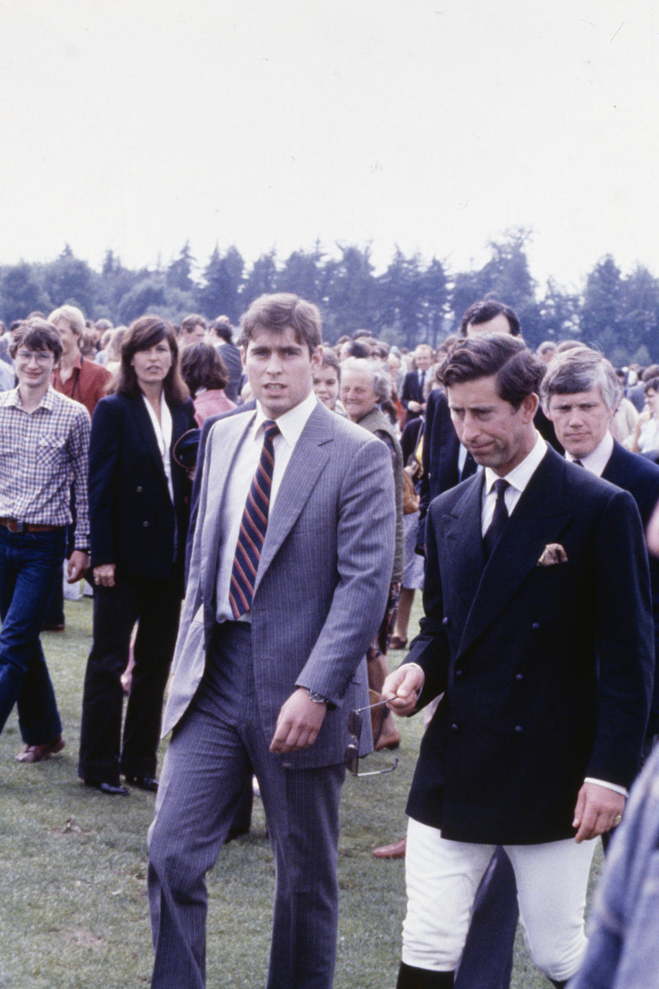 The two princes, Andrew and Charles stand among several dozen on-lookers.