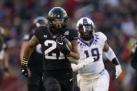 Iowa State running back Jirehl Brock (21) runs from TCU linebacker Shadrach Banks (19) during a 40-yard touchdown run in the first half an NCAA college football game, Friday, Nov. 26, 2021, in Ames, Iowa. (AP Photo/Charlie Neibergall)