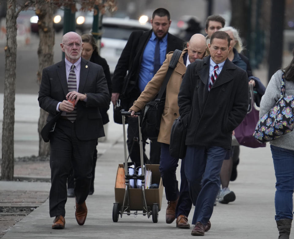 Michael J. Allen, front, district attorney for Colorado's Fourth Judicial District, leads attorneys into the El Paso County courthouse for a preliminary hearing for the alleged shooter in the Club Q mass shooting Wednesday, Feb. 22, 2023, in Colorado Springs, Colo. (AP Photo/David Zalubowski)