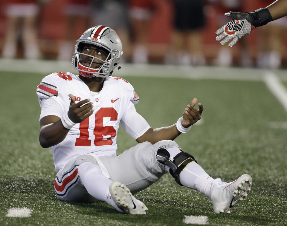 Ohio State quarterback J.T. Barrett looks up at an Indiana player after being hit on a pass. (AP)