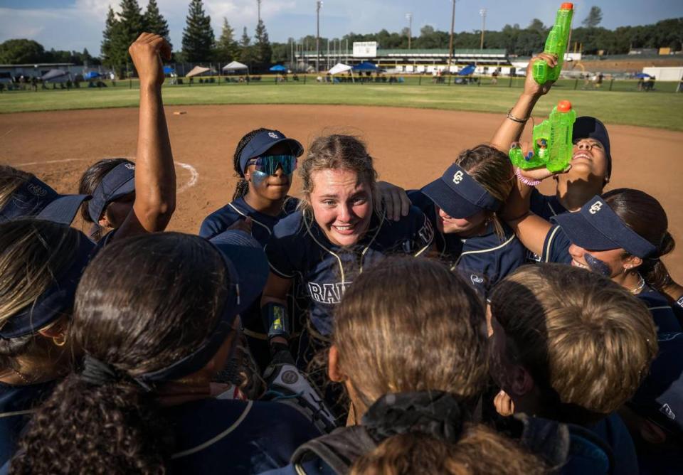 Central Catholic pitcher Raiders Randi Roelling (34), center, is surrounded by her team after the last out of their 7-0 win over the Ponderosa Bruins for the CIF Northern California Division III softball championship title Saturday, June 3, 2023, at Ponderosa High School in Shingle Springs.