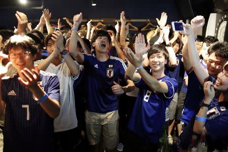 Japanese fans react as they watch a broadcast of the World Cup Round of 16 soccer match Belgium vs Japan at a sports bar in Tokyo, Japan July 3, 2018. REUTERS/Issei Kato