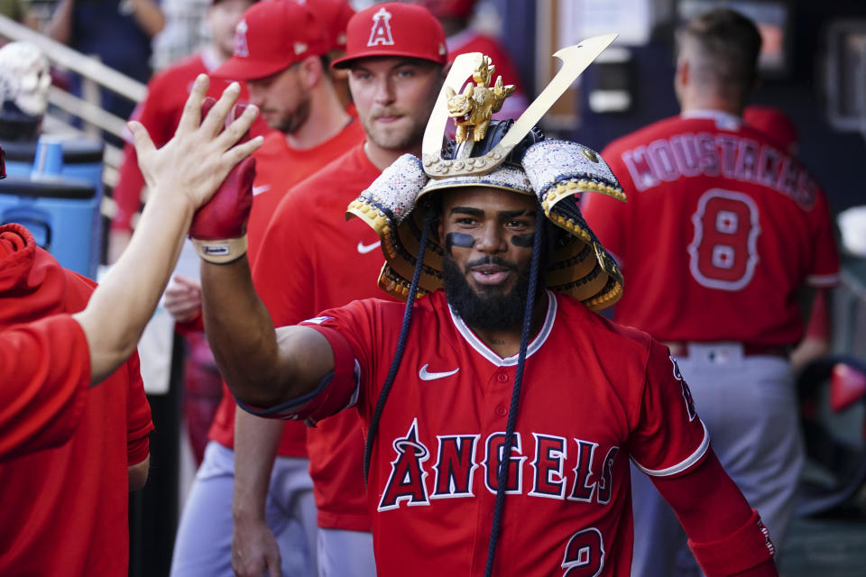 Los Angeles Angels' Luis Rengifo (2) wears a samurai warrior's helmet as he celebrates after his home run in the first inning of a baseball game against the Atlanta Braves, Monday, July 31, 2023, in Atlanta. (AP Photo/John Bazemore)