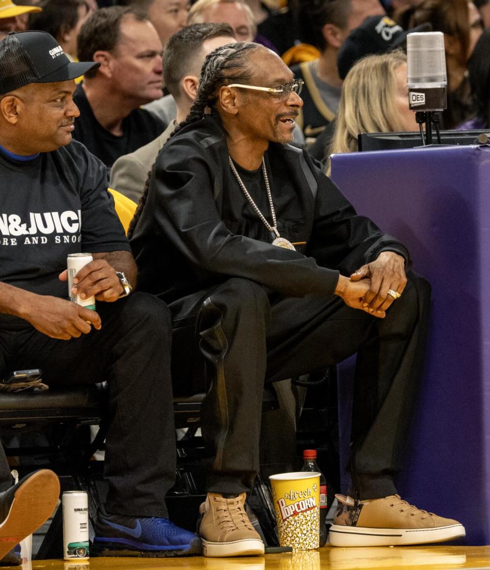 Snoop Dog stands courtside as the Lakers play the Nuggets in Game 3 of the NBA playoff series at Crypto.com Arena