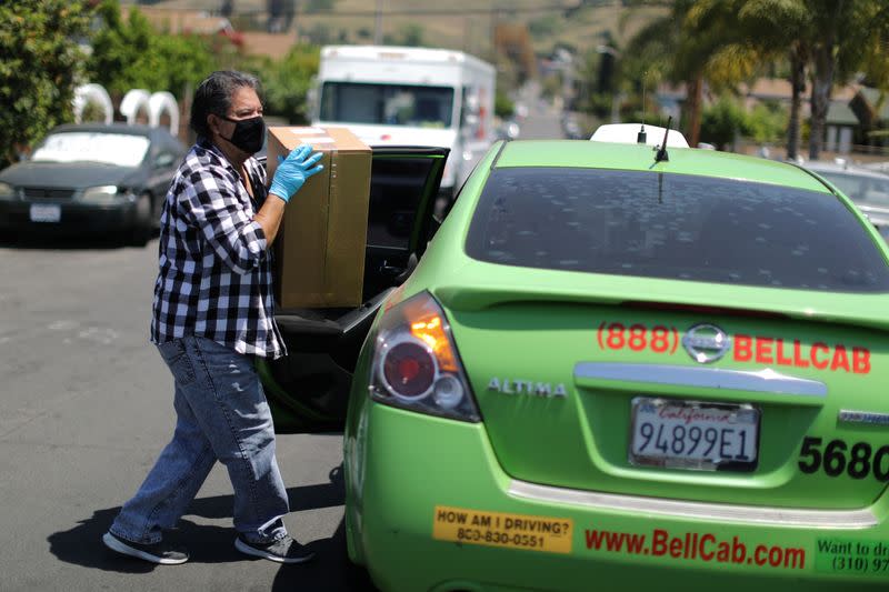 Taxi driver Gomez delivers food from the Westin Bonaventure hotel to at-risk seniors as the global outbreak of the coronavirus disease (COVID-19) continues in Los Angeles