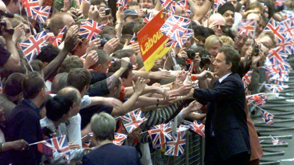 Newly elected British Prime Minister Tony Blair is greeted by a sea of well-wishers in Downing Street, on May 2, 1997. Blair's Labour Party won a landslide victory, ending 18 years of Conservative rule. - Adam Butler/AP