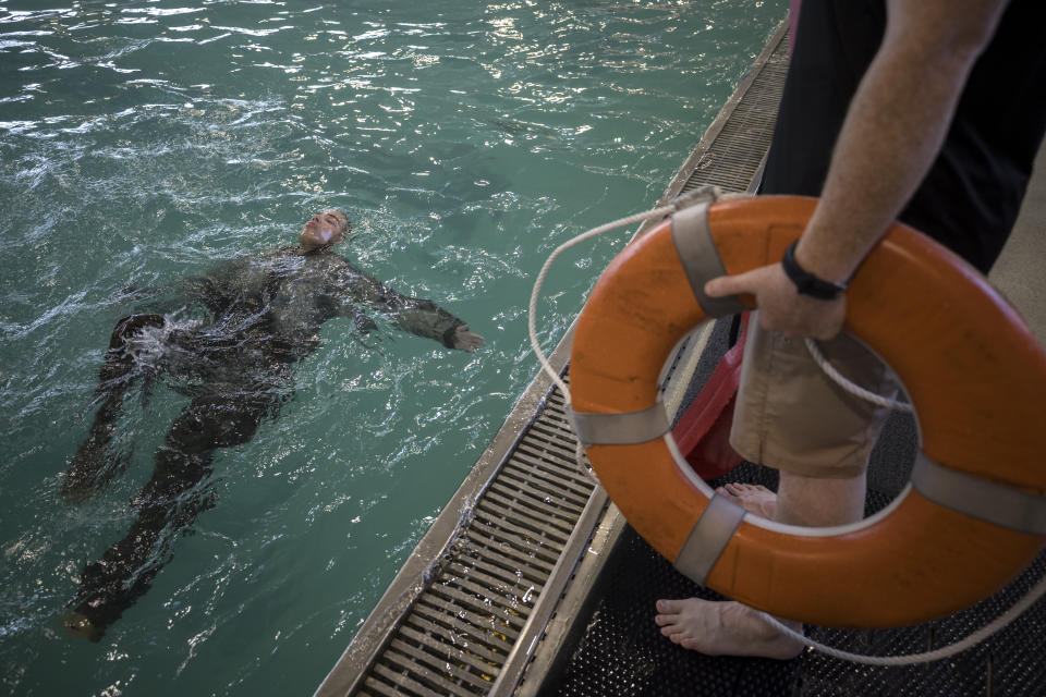 A male U.S. Marine Corps swim instructor, right, watches over a recruit during swim training at the Marine Corps Recruit Depot pool, Wednesday, June 28, 2023, in Parris Island, S.C. (AP Photo/Stephen B. Morton)