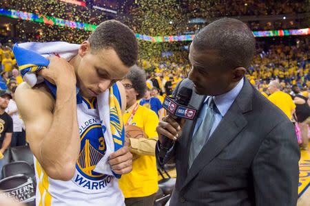 May 18, 2016; Oakland, CA, USA; Golden State Warriors guard Stephen Curry (30) looks at his bruise while being interviewed by TNT reporter David Aldridge (right) after game two of the Western conference finals of the NBA Playoffs against the Oklahoma City Thunder at Oracle Arena. The Warriors defeated the Thunder 118-91. Mandatory Credit: Kyle Terada-USA TODAY Sports