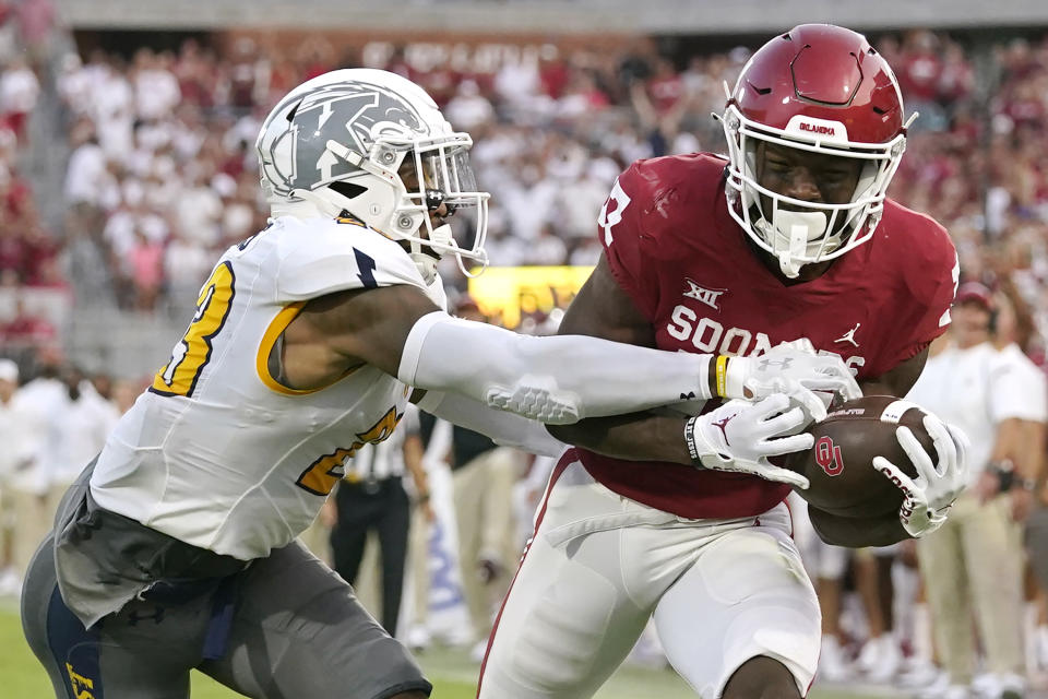 Oklahoma wide receiver Marvin Mims (17) catches a touchdown pass in front of Kent State safety JoJo Evans (23) during the first half of an NCAA college football game Saturday, Sept. 10, 2022, in Norman, Okla. (AP Photo/Sue Ogrocki)