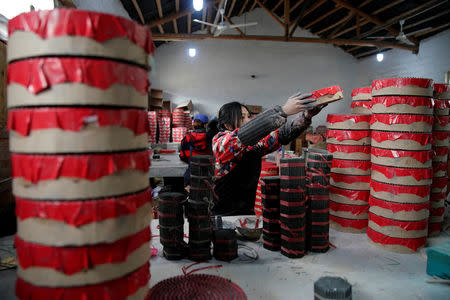 A worker processes pyrotechnic product at Liuyang Standard Fireworks Manufactory in Liuyang, Hunan province, China January 29, 2018, Picture taken January 29, 2018. REUTERS/Aly Song