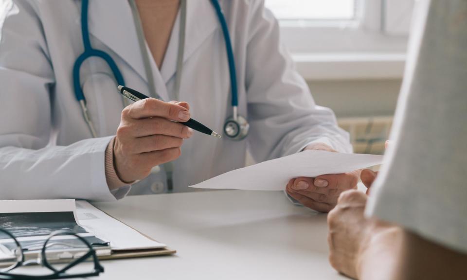 <span>The government is planning to trial the issuing of fit notes, until last year overseen by GPs, by ‘work and health professionals’.</span><span>Photograph: Natalia Gdovskaia/Getty Images</span>