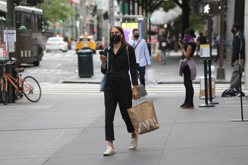 NEW YORK, NEW YORK - JULY 01: A person walks with a Zara shopping bag as New York City moves into Phase 2 of re-opening following restrictions imposed to curb the coronavirus pandemic on July 1, 2020 in New York, New York. Phase 2 permits the re-opening of office jobs, real estate services, in-store retail services such as rentals, repairs and hair salons, and outdoor dining. (Photo by Rob Kim/Getty Images)