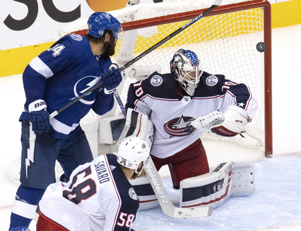 Columbus Blue Jackets goaltender Joonas Korpisalo (70) makes a save as Tampa Bay Lightning left wing Pat Maroon (14) closes in with Jackets defenseman David Savard (58) looking on during third-period of NHL Eastern Conference Stanley Cup first round playoff hockey game action in Toronto, Thursday, Aug. 13, 2020. (Frank Gunn/The Canadian Press via AP)