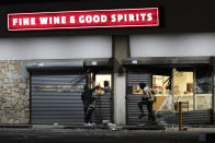 A Pennsylvania Liquor Control Board retail store is vandalized during the early morning hours on Wednesday, Sept. 27, 2023, in Philadelphia. A flash mob-style ransacking and vandalism to downtown stores Tuesday night came after a peaceful protest over a judge’s decision to dismiss murder and other charges against a Philadelphia police officer who shot and killed a driver, Eddie Irizarry, through a rolled-up window. (Elizabeth Robertson/The Philadelphia Inquirer via AP)