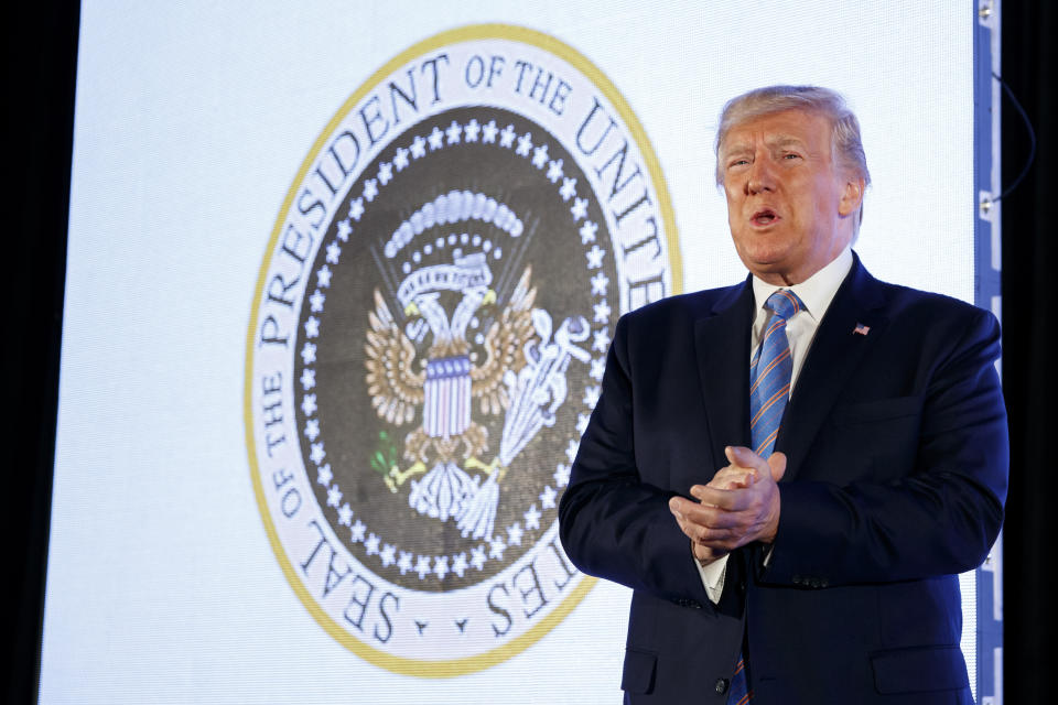 President Donald Trump speaks to a college Republican group as the doctored presidential seal showing Russian symbols and golf clubs is projected behind him. (Photo: ASSOCIATED PRESS)