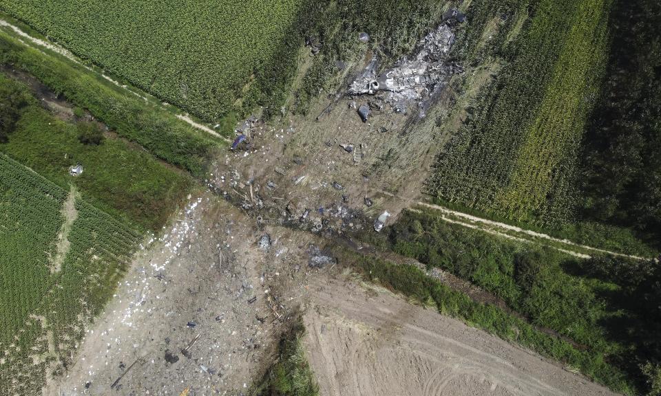 This drone photo shows the site where the AN-12 cargo plane crashed, in Palaiochori village near the town of Kavala, in northern Greece, Sunday, July 17, 2022. Experts are poised to investigate the site of a plane crash in northern Greece to determine whether any dangerous chemicals or explosive cargo remains. (AP Photo/Giannis Papanikos)