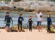 <p>Doting father Keith went to greet the girls at the water's edge with his friend and daughter along with Sunday and Faith who were carrying their surfboards onto the sand.</p>