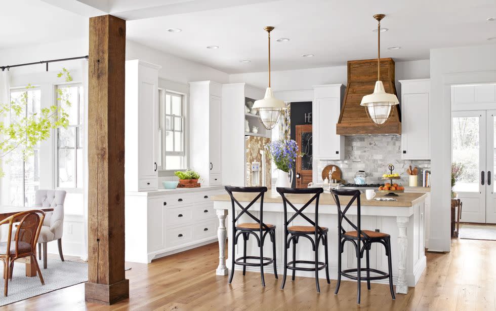 a white farmhouse kitchen ideas with salvaged wood details in the range hood