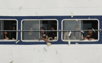 Relatives of victims who died in Monday's ferry collision throw paper money to pay tribute to those lost, Thursday, Oct. 4, 2012, in Hong Kong. A show of concern by Beijing over the boat collision that killed dozens of people in Hong Kong this week has backfired, further damaging the communist government's image in the former British colony. (AP Photo/Kin Cheung)