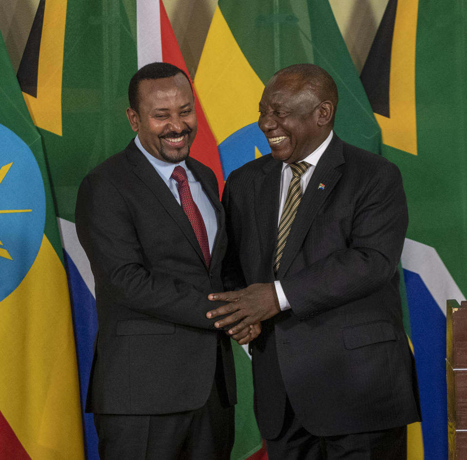 South African President Cyril Ramaphosa, right, shakes hand with Ethiopia's Prime Minister Abiy Ahmed after their joint media conference at the Union Building in Pretoria, South Africa, Sunday, Jan. 12, 2020. (AP Photo/Themba Hadebe)