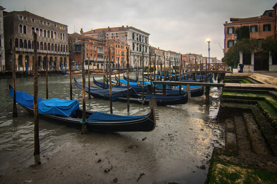 <p>Gondolas lay stuck along Venice, Italy’s Grand Canal near Rialto bridge because of an exceptionally low tide on Jan. 30, 2018 in Venice, Italy. The low tide created problems in transport and navigation in the city, which uses canals instead of roads. Photo from Simone Padovani/Awakening/Getty Images. </p>