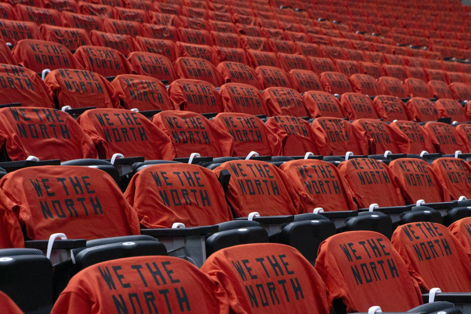 FILE - In this June 10, 2019, file photo, T-shirts rest on seats at Scotiabank Arena before Game 5 of the NBA Finals between the Golden State Warriors and Toronto Raptors in Toronto. The Canadian government has denied a request by the NBA and the Raptors to play in Toronto amid the pandemic. An official familiar with the federal government’s decision told The Associated Press on Friday, Nov. 20, 2020, there is too much COVID-19 circulating in the United States to allow for cross-border travel that is not essential. (Chris Young/The Canadian Press via AP)