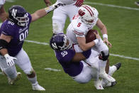 Wisconsin quarterback Graham Mertz is sacked by Northwestern defensive end Eku Leota during the first half of an NCAA college football game in Evanston, Ill., Saturday, Nov. 21, 2020. (AP Photo/Nam Y. Huh)