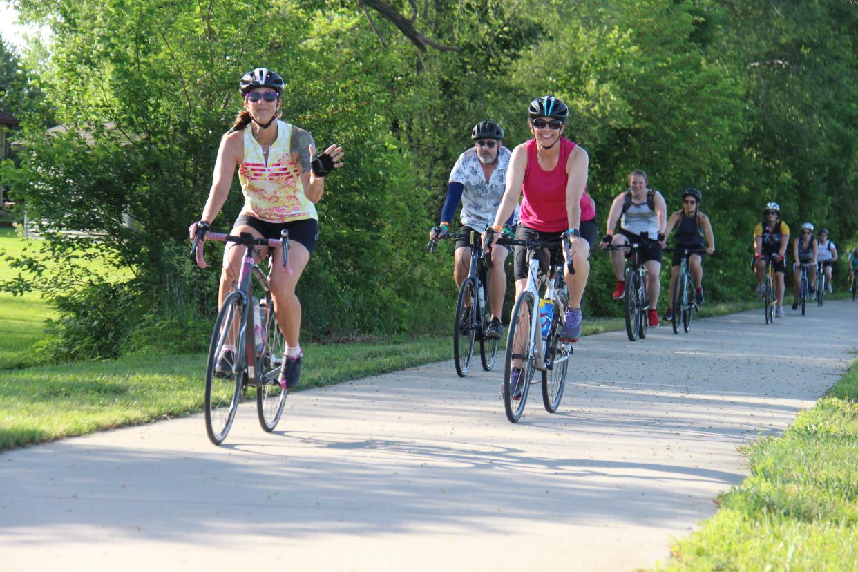 Riders make their way into Dallas Center on the Raccoon River Valley Trail as part of the BACooN Ride on Saturday, June 18, 2022.