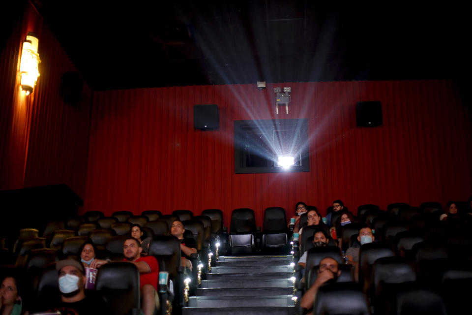 People watch a movie at a cinema after almost a year of theaters being closed due to the COVID-19 pandemic, in Buenos Aires, Argentina, Wednesday, March 3, 2021. (AP Photo/Natacha Pisarenko)