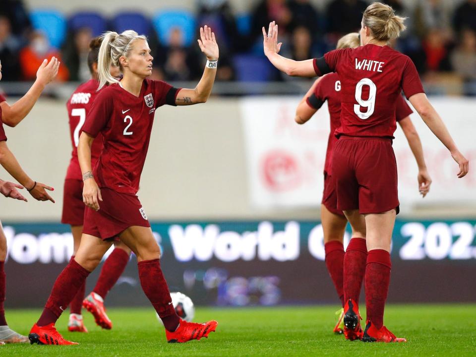 Rachel Daly high-fives teammates during England's match against Luxembourg.