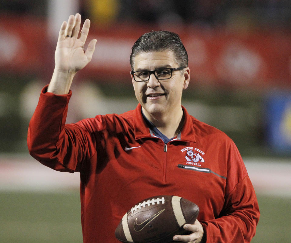 FILE - In this Nov. 4, 2017 file photo, Fresno State president Joseph I. Castro waves to the crowd before an NCAA college football game against BYU in Fresno, Calif. Castro was chosen to be the new chancellor of the California State University, becoming the first Mexican-American and native Californian to lead the nation's largest four-year public university system. The CSU Board of Trustees announced the appointment of Castro on Wednesday, Sept. 23, 2020. He will replace Chancellor Timothy White, who is retiring. (AP Photo/Gary Kazanjian, File)