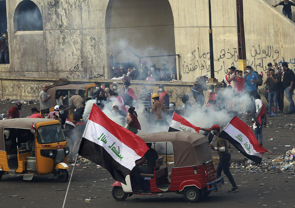 Iraq security forces fire tear gas to disperse anti-government protesters during a demonstration in Baghdad, Iraq, Monday, Oct. 28, 2019. Protests have resumed in Iraq after a wave of anti-government protests earlier this month were violently put down. (AP Photo/Hadi Mizban)