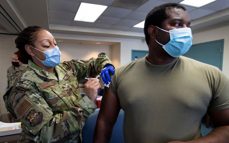 Capt. Shamira Conerly, 149th Medical Group, gives Staff Sgt. Timmy Sanders, 149th Maintenance Squadron, his first dose of COVID-19 vaccine at Joint Base San Antonio-Lackland in Texas on March 18, 2021. (Senior Airman Ryan Mancuso/Air National Guard)<cite class="op-small">(Senior Airman Ryan Mancuso)</cite>