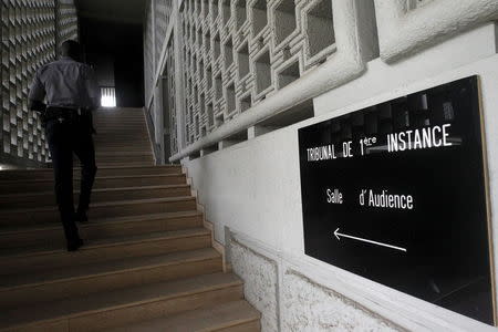 A security force soldier climbs the stairs at the court of Abidjan July 2, 2015. Picture taken July 2, 2015. REUTERS/Luc Gnago