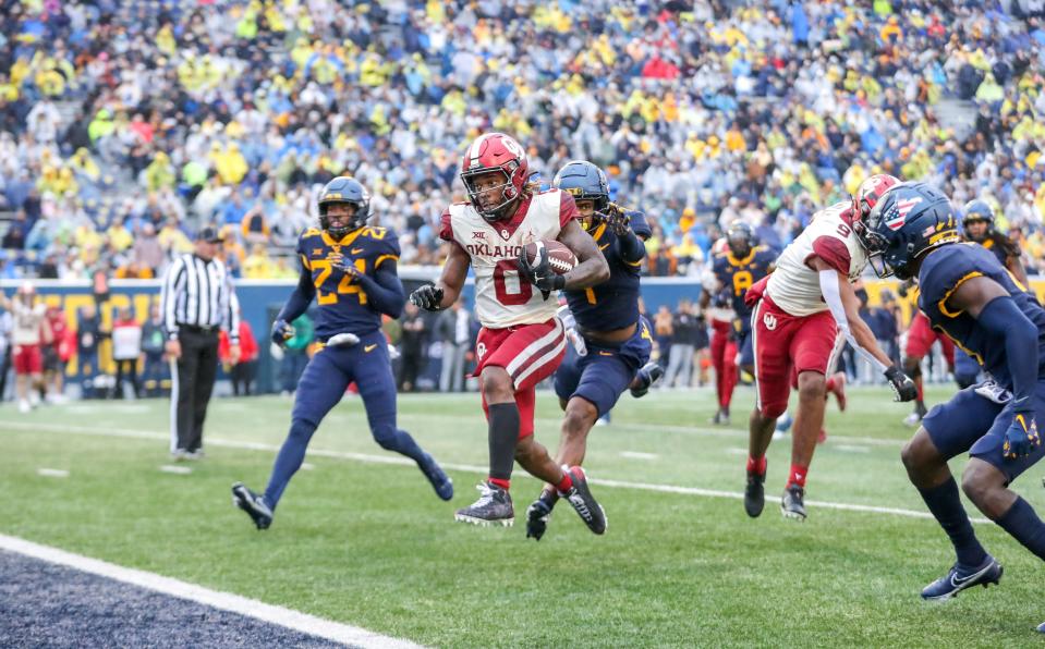 Oklahoma running back Eric Gray runs the ball for a touchdown during the second quarter against West Virginia at Mountaineer Field at Milan Puskar Stadium.