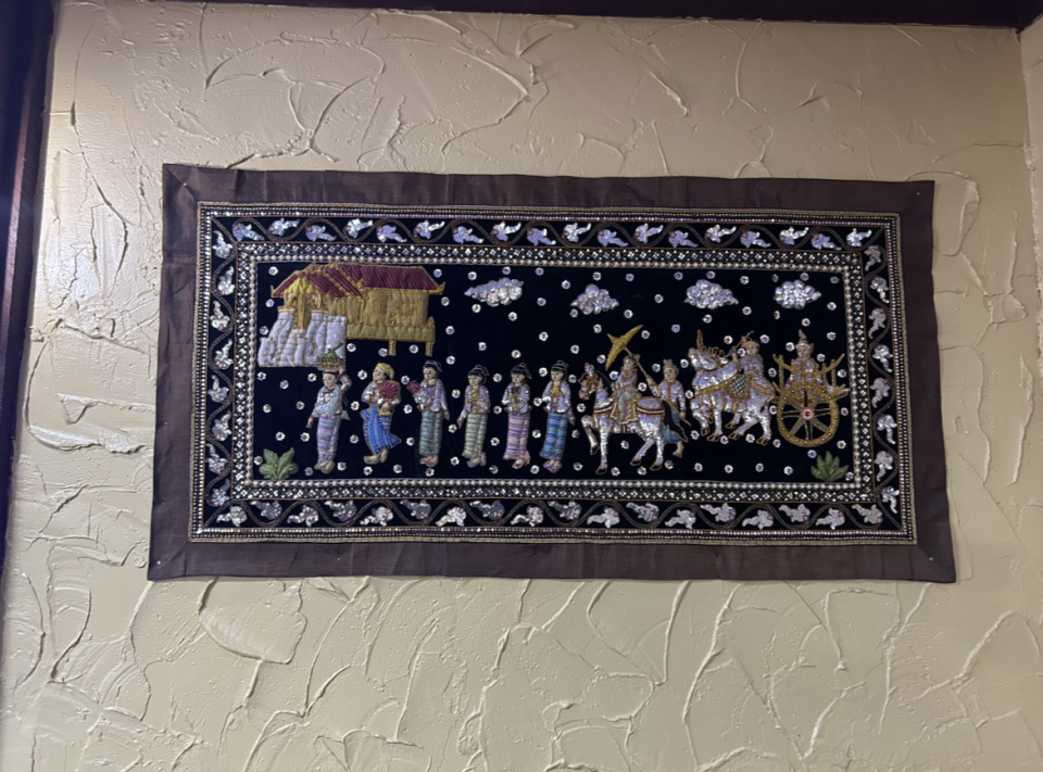 An Asian tapestry adorns a wall at Lyeh Thai Restaurant in Akron's North Hill.