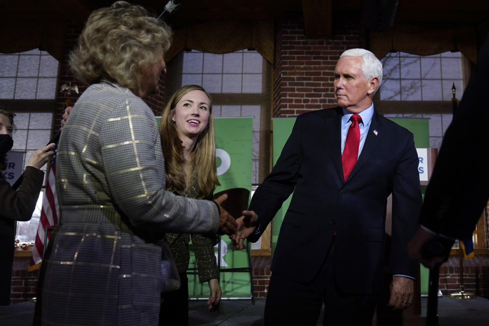 Former Vice President Mike Pence shakes hands with guests during a gathering, Wednesday, Dec. 8, 2021, in Manchester, N.H. At center rear is Jessica Anderson, executive director of Heritage Action. (AP Photo/Charles Krupa)