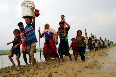 Rohingya refugees walk on the muddy path after crossing the Bangladesh-Myanmar border in Teknaf, Bangladesh, September 3, 2017. REUTERS/Mohammad Ponir Hossain