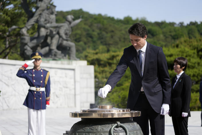 Canadian Prime Minister Justin Trudeau burns incense at the National Cemetery in Seoul, South Korea, Wednesday, May 17, 2023. (AP Photo/Lee Jin-man, Pool)
