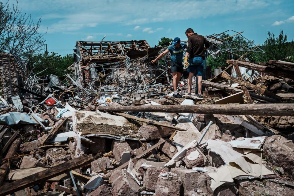 Residents at a house destroyed by a bomb.