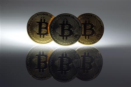 Mock Bitcoins are displayed on a table in an illustration picture taken in Berlin January 7, 2014. REUTERS/Pawel Kopczynski