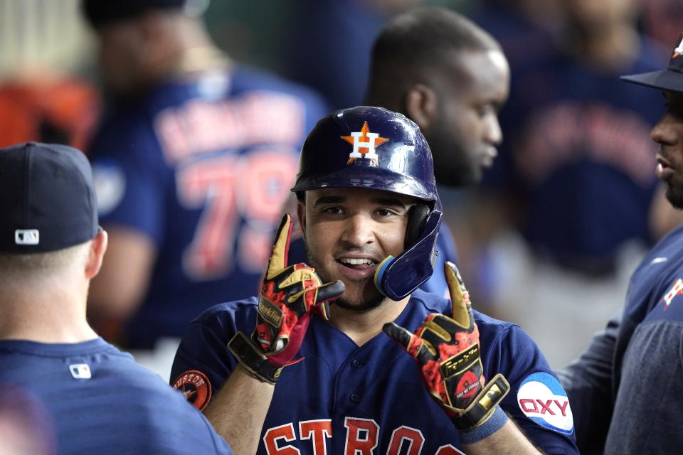 Houston Astros' Yainer Diaz celebrates in the dugout after hitting a home run against the Los Angeles Angels during the fifth inning of a baseball game Sunday, June 4, 2023, in Houston. (AP Photo/David J. Phillip)