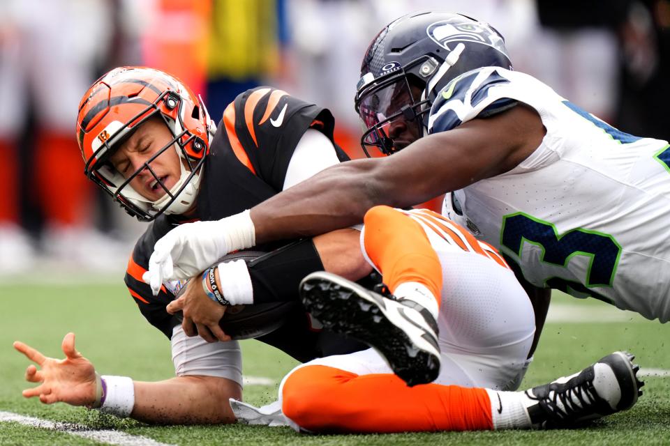 Cincinnati Bengals quarterback Joe Burrow (9) is sacked by Seattle Seahawks linebacker Boye Mafe (53).