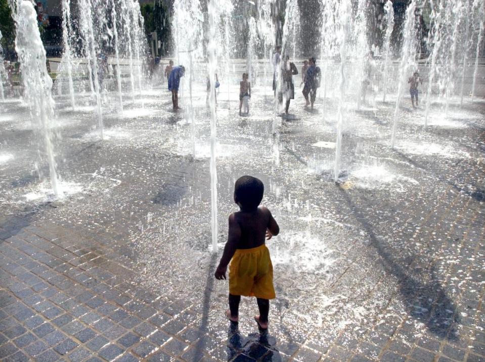 Gabirel Howell, 2, is a bit nervous about jumping in to the fountain in front of Crown Center in 2003. File/The Kansas City Star