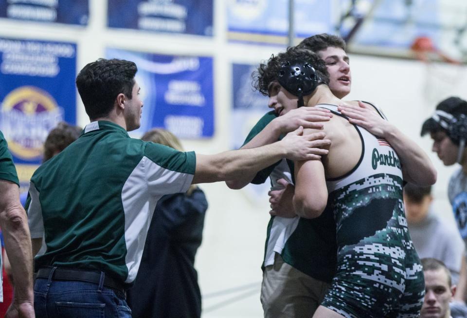 Pleasantville's Asa Nunberg (green) celebrates with coaches after defeating Fordham Prep's Jaziah Moore (red) in the 172-pound finals of the Murphy-Guccione Shoreline Classic wrestling tournament at New Rochelle High School on Saturday, Jan. 7, 2023.