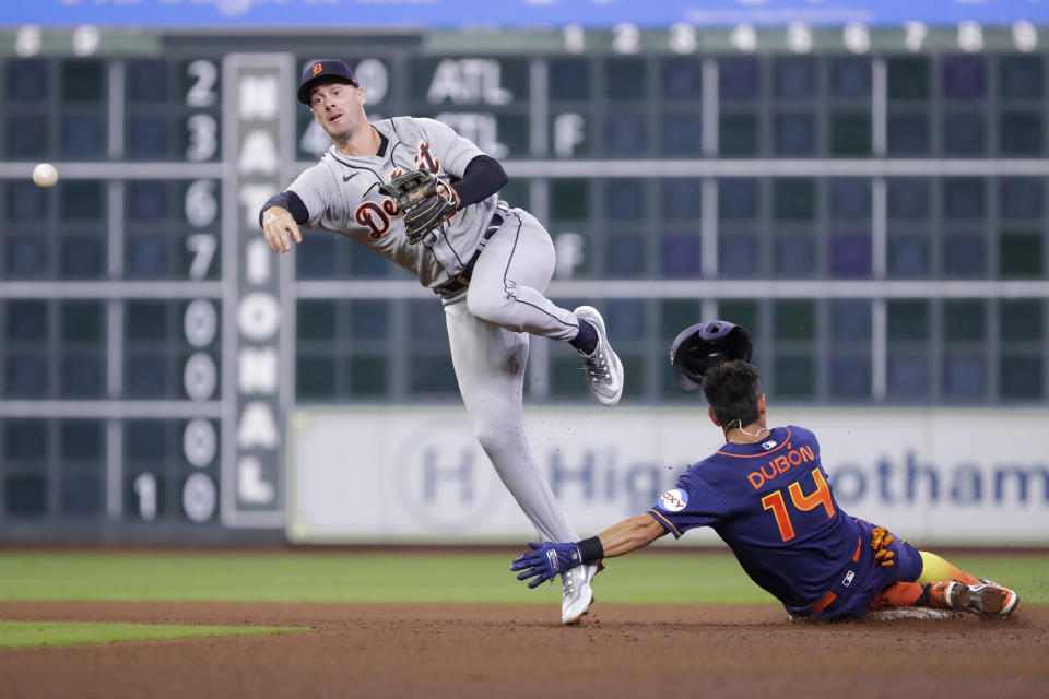 Detroit Tigers shortstop Ryan Kreidler, left, jumps to avoid the collision at second base as he turns a double play over Houston Astros runner Mauricio Dubon (14) during the eighth inning of a baseball game Monday, April 3, 2023, in Houston. (AP Photo/Michael Wyke)