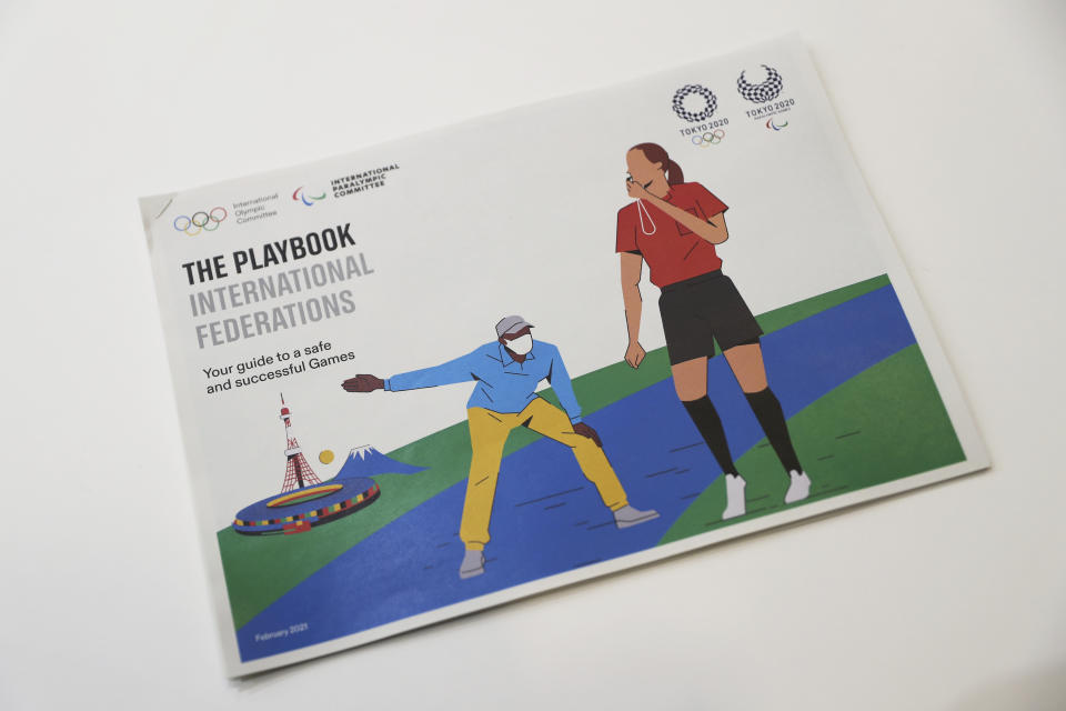 This photo shows the first version of "The Playbooks" revealed during a Joint press briefing in Tokyo on Wednesday, Feb. 3, 2021. Representatives from the Tokyo Organizing Committee of the Olympic and Paralympic Games (Tokyo 2020), the International Olympic Committee (IOC) and the International Paralympic Committee (IPC) announced Wednesday they jointly developed and published the first version of "The Playbooks," which contains advice from international and Japanese health experts for COVID-19 countermeasures as well as the guidelines and rules that each games stakeholder will need to observe in order to play their part in ensuing a safe and secure games. (Du Xiaoyi/Pool Photo via AP)