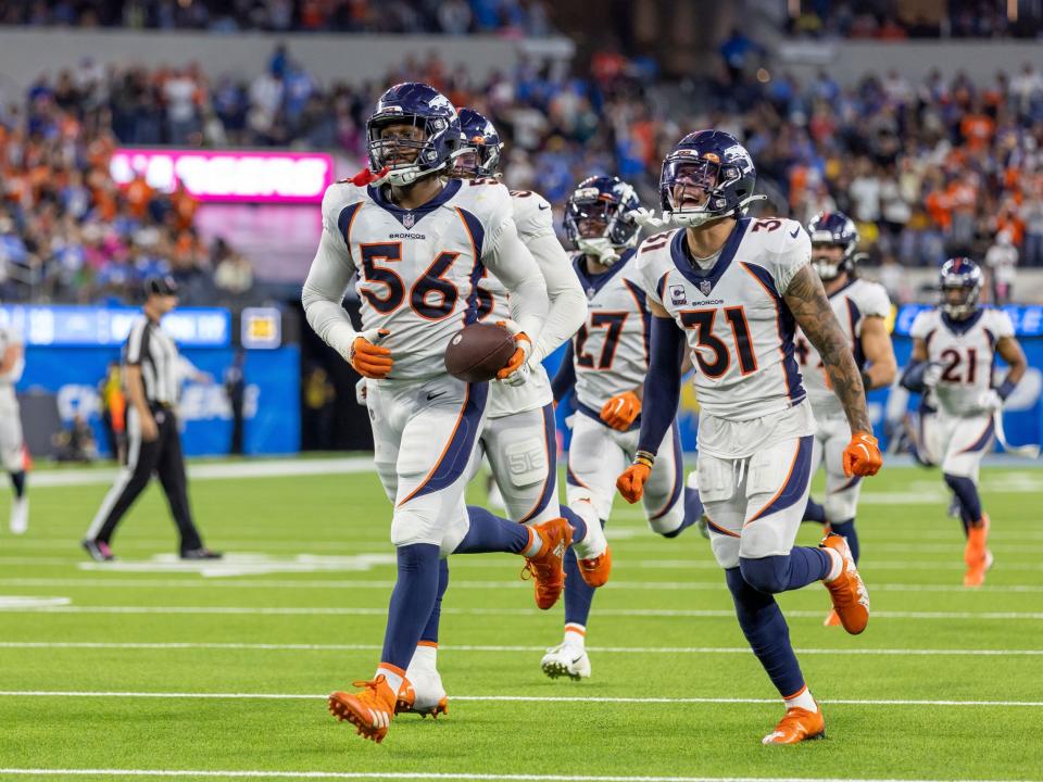 Denver Broncos defense celebrates a turnover against the Los Angeles Chargers.